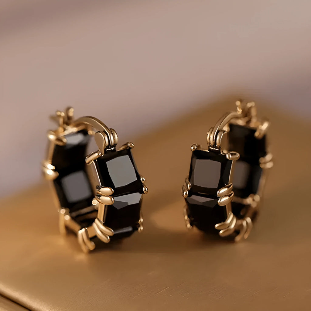 Geometric U-shaped gold tone earrings with round black zircon stone.
