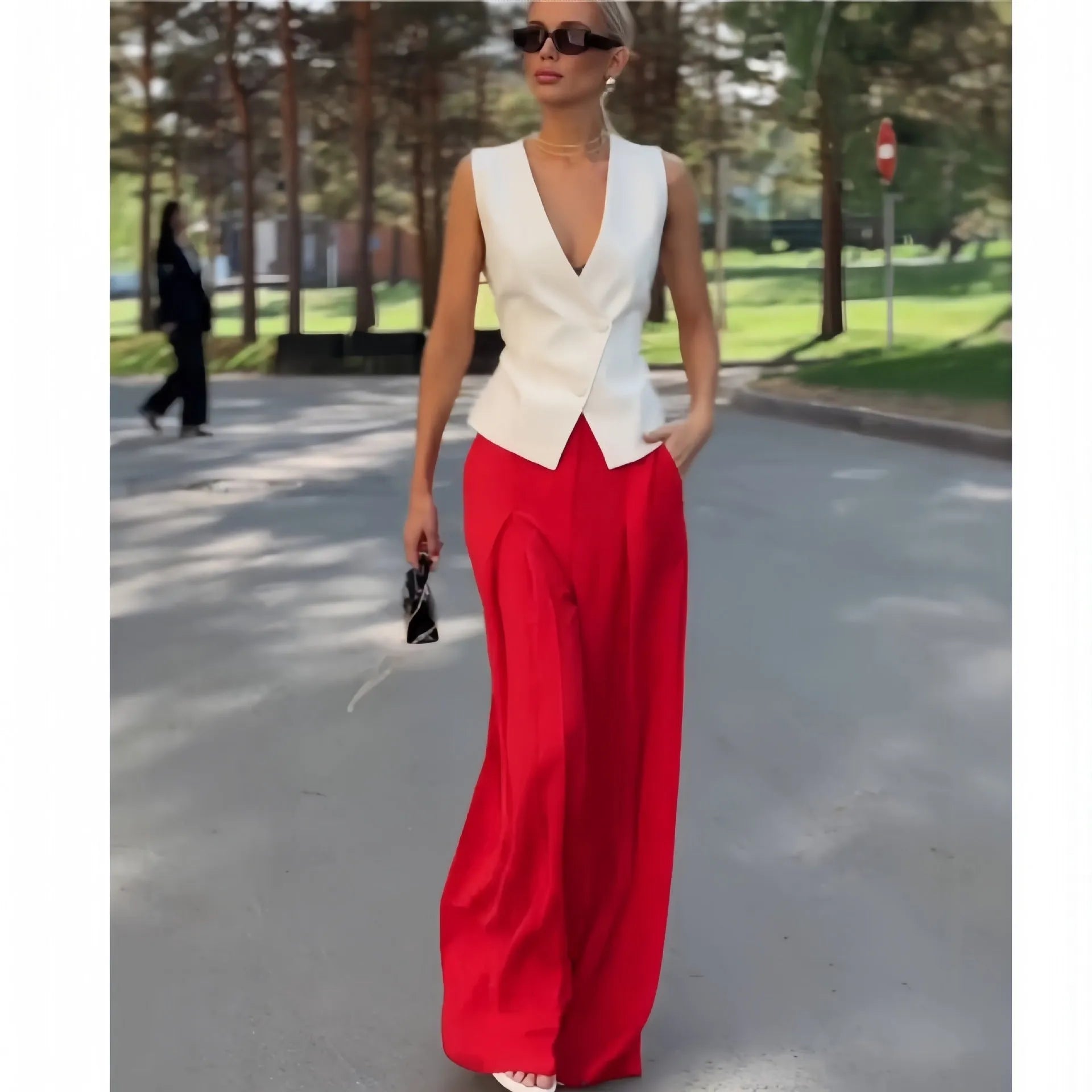 Women's beige two-piece set with deep V-neck sleeveless top and wide-leg trousers