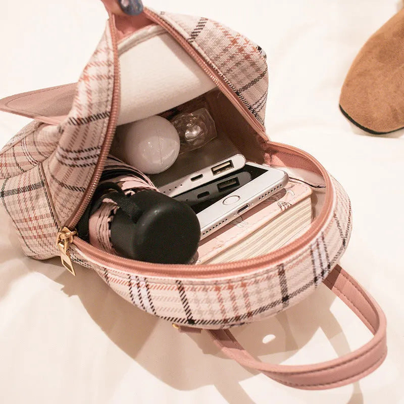 A black PU one shoulder diagonal phone bag worn crossbody, also shown held in hand.