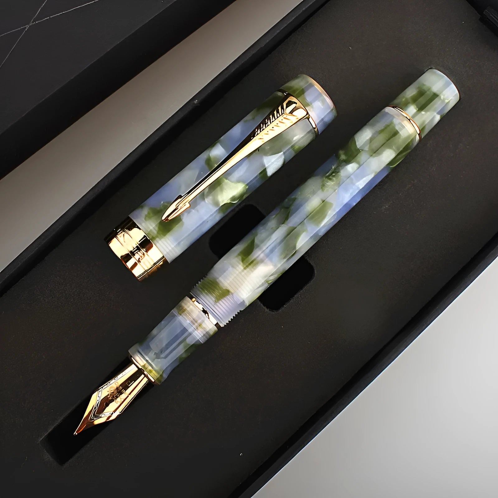 Deep green metal ballpoint pen with three tip size options for writing and drawing