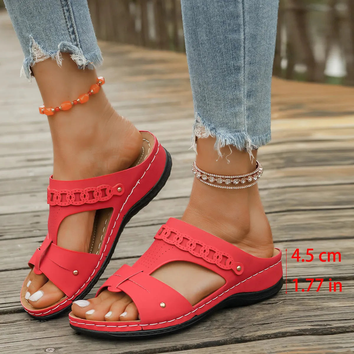Blue Roman-style slippers with a fish mouth toe holder and slope heel on a rubber sole.