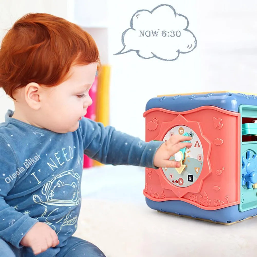 Colourful six-sided Montessori educational toy cube showing bead maze, gears, car track, clock, butterfly, and number activities