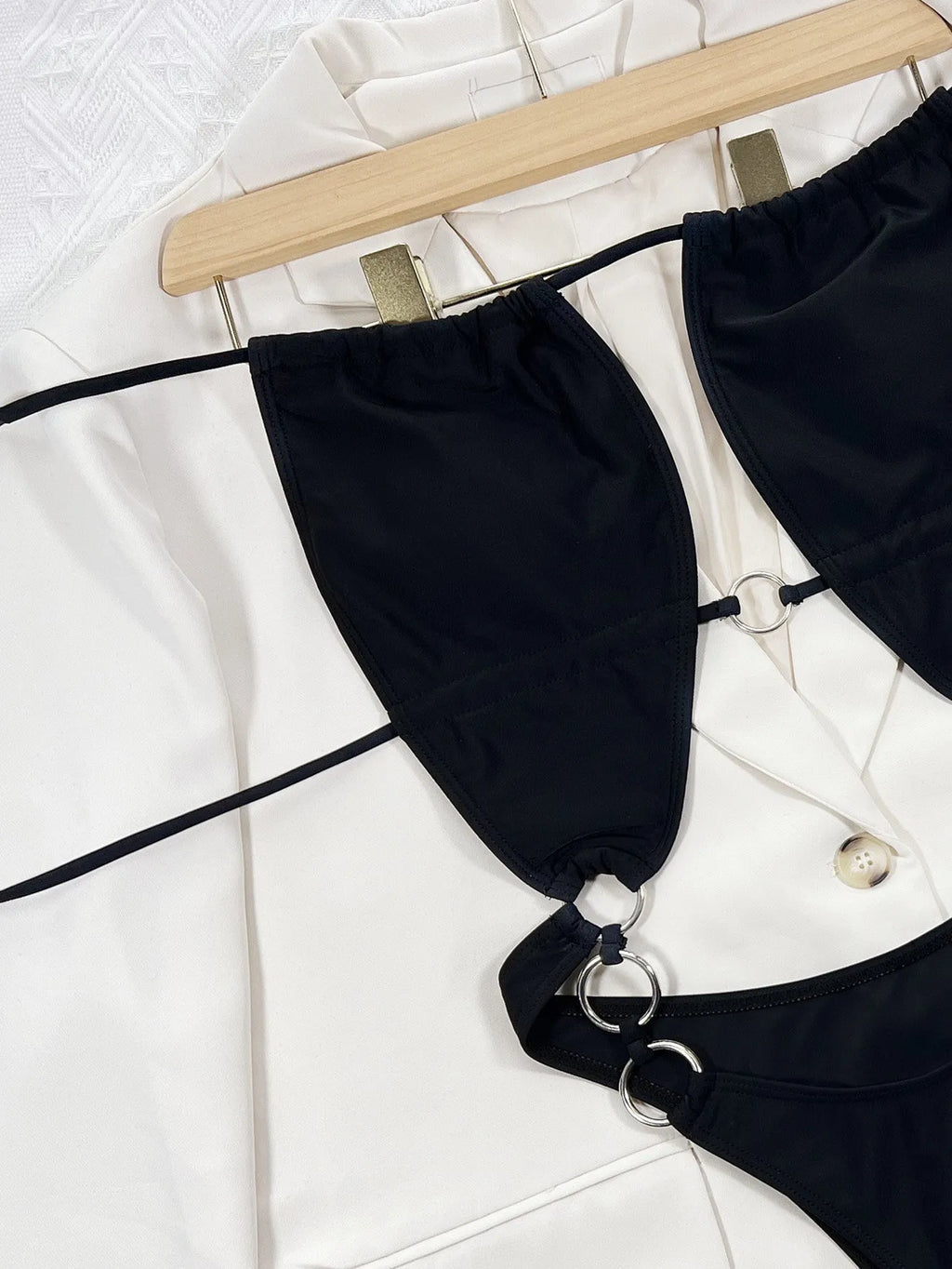 Black women's one-piece swimsuit with steel ring detail on sleeveless nylon design