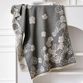 Grey imitation cashmere winter shawl with tassels, shown draped.
