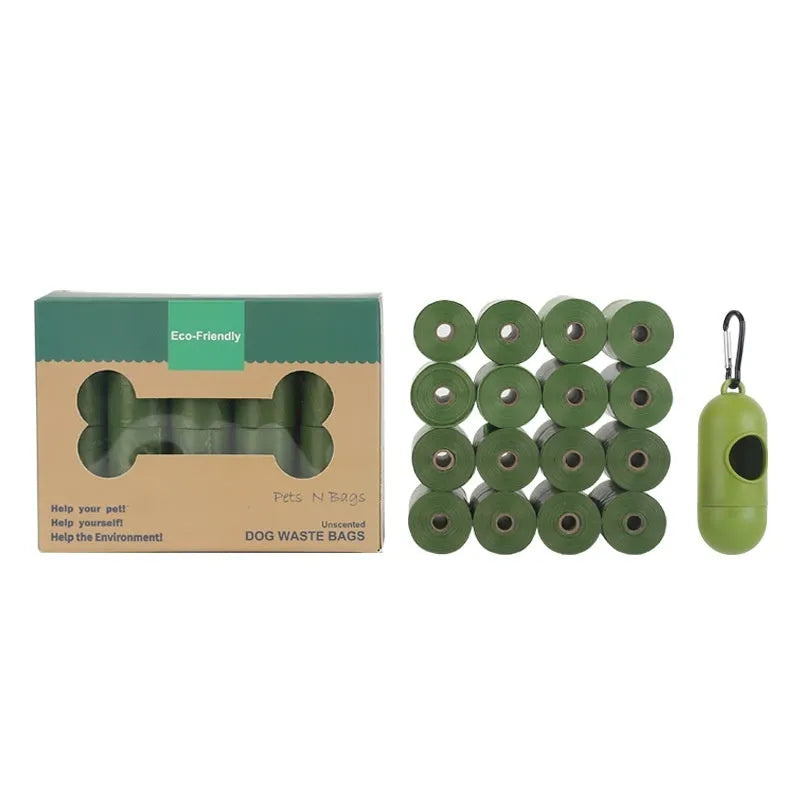 Rolls of green EPI degradable pet waste bags next to a transparent dispenser unit.