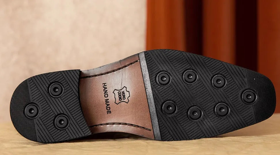 Men's black genuine leather slip-on loafers with a fringed design and rubber sole.