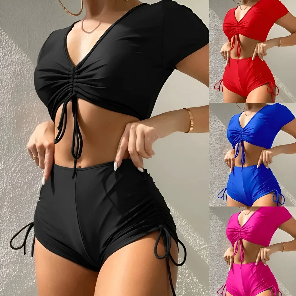 Women's lace-up bow swimsuit top with matching shorts in dark green.