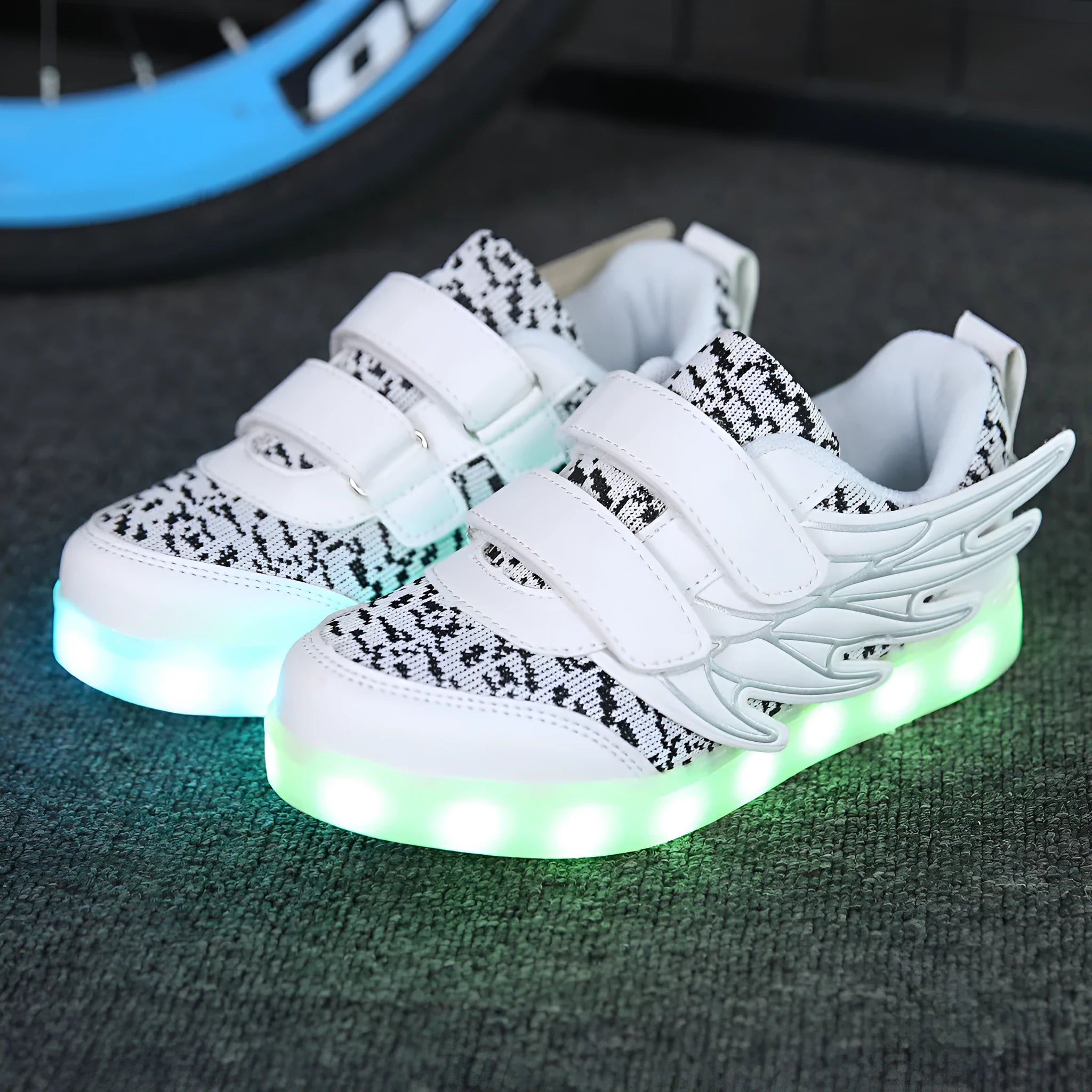 Plum red children's LED light-up sneakers on a white background, showing USB charging port.