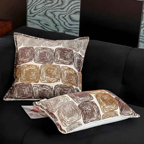 Cream and coffee coloured abstract coil pattern square pillow cover made from polyester feather velvet.