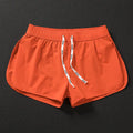 Men's loose beach shorts in orange, fluorescent green and black colours with elastic polyester fabric