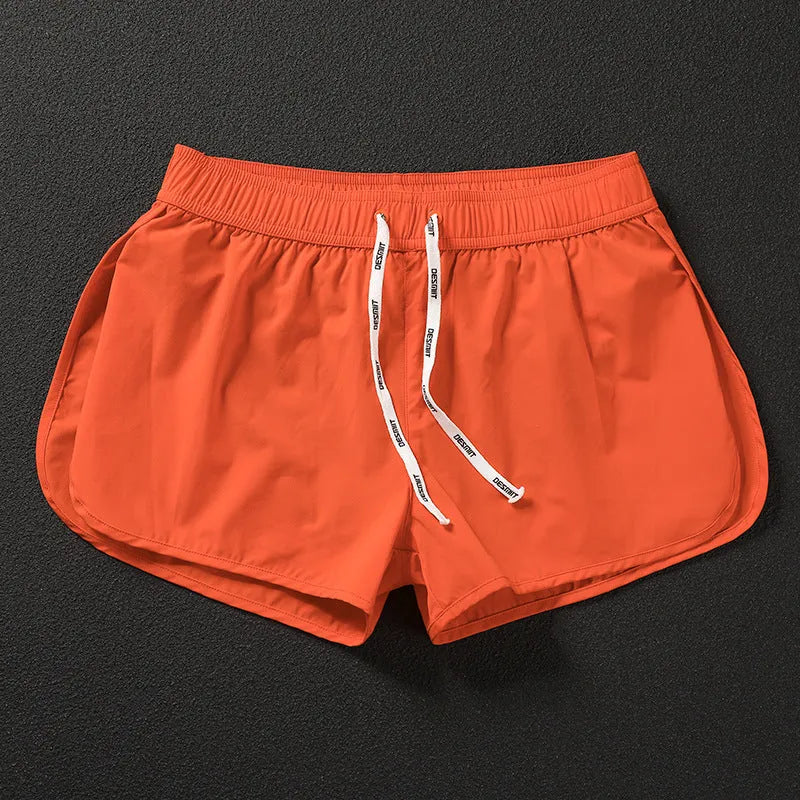 Men's loose beach shorts in orange, fluorescent green and black colours with elastic polyester fabric