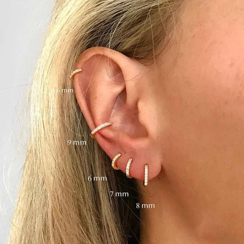 Circle-shaped zircon stud earrings in gold, rose gold, or silver colour on a white background.