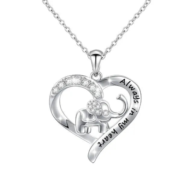 Silver alloy elephant pendant necklace with personalised letter charm on a flat surface