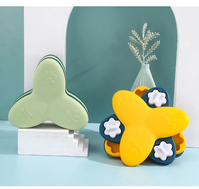 Green and yellow dog puzzle toy with rotatable treat dispenser and nine bone-shaped compartment covers