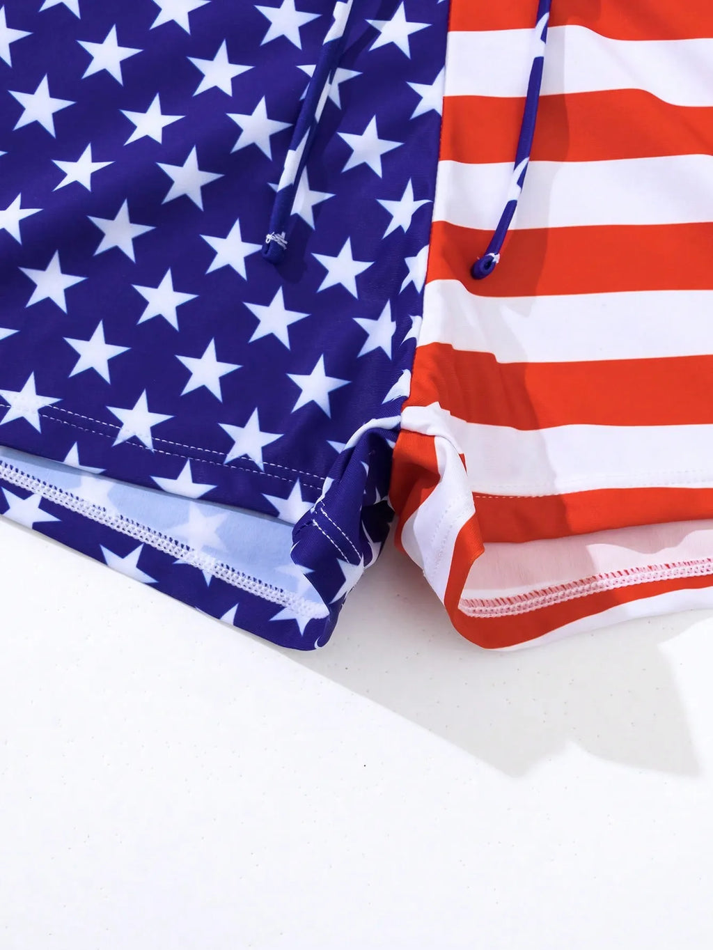 Women's high waist swimsuit briefs with boxer legs and a drawstring waist in a red, white, and blue Stars and Stripes pattern.