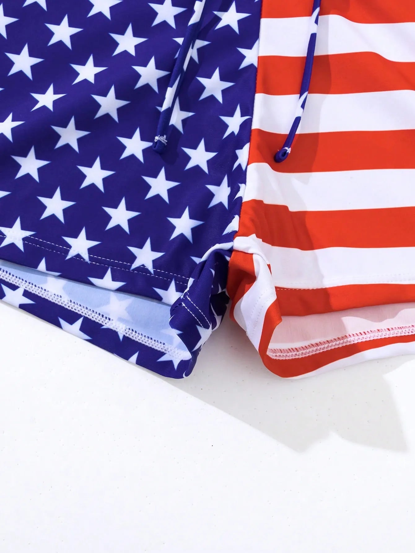 Women's high waist swimsuit briefs with boxer legs and a drawstring waist in a red, white, and blue Stars and Stripes pattern.