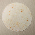 Round coral fleece burrito blanket with printed design on soft flannel fabric.