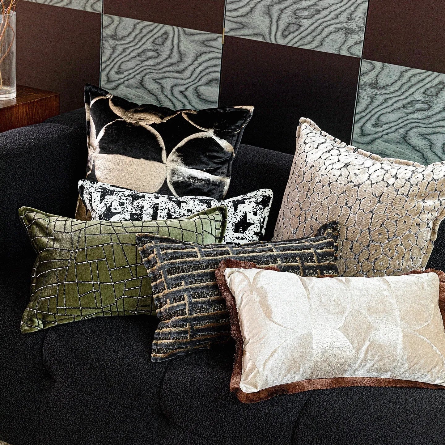 Black and gold abstract pattern cushion with flannel cover on a grey sofa