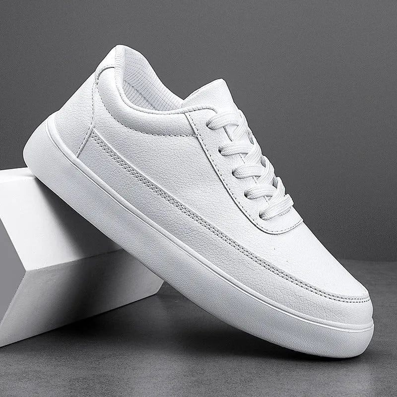 Women's white leather flat lace-up casual shoes on a plain background