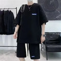 Man wearing a grey waffle-textured short sleeve leisure top and matching shorts.