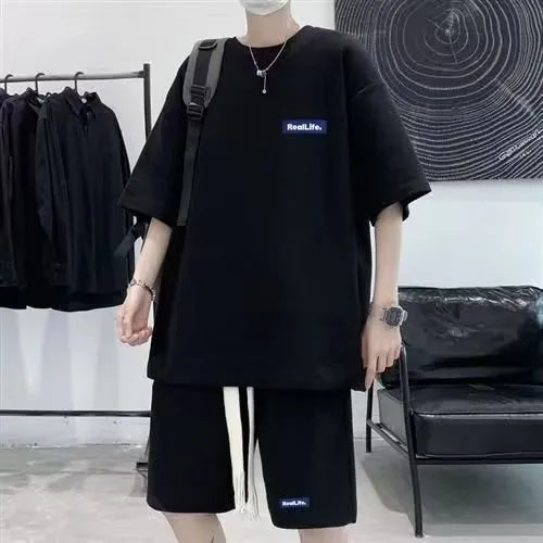 Man wearing a grey waffle-textured short sleeve leisure top and matching shorts.