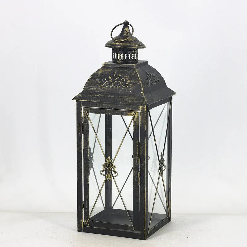 Black and white wrought iron floor-standing storm lantern with tempered glass panels in three sizes for courtyards.