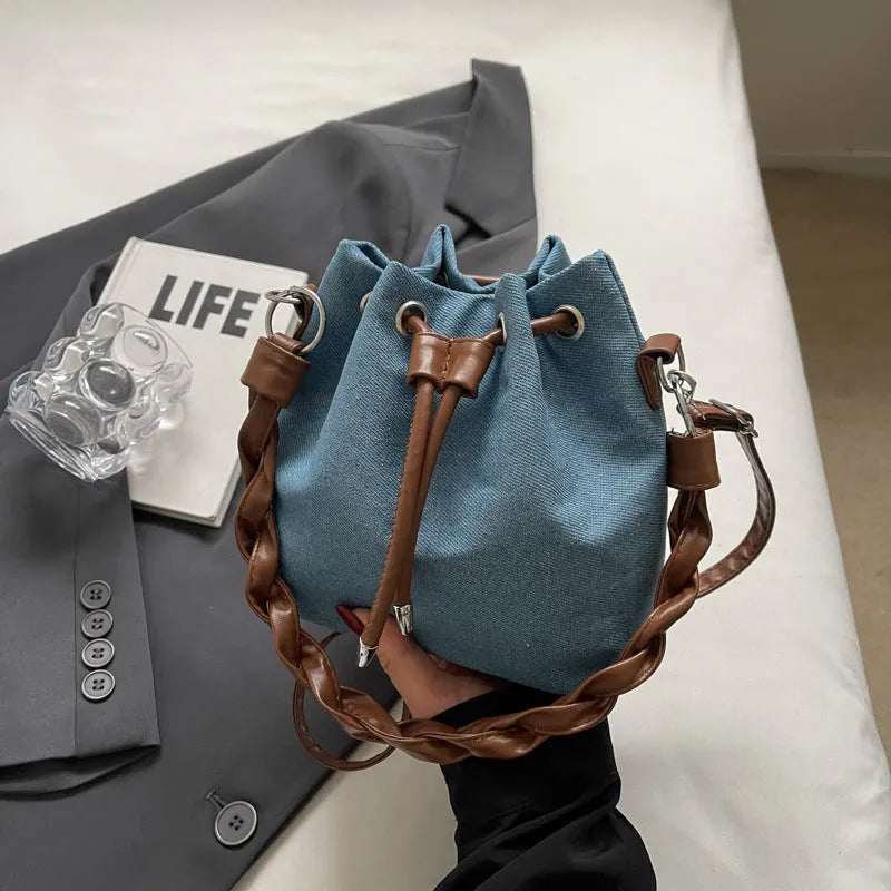 Blue one-shoulder cross body bucket bag with synthetic leather lining and sandwich pocket design