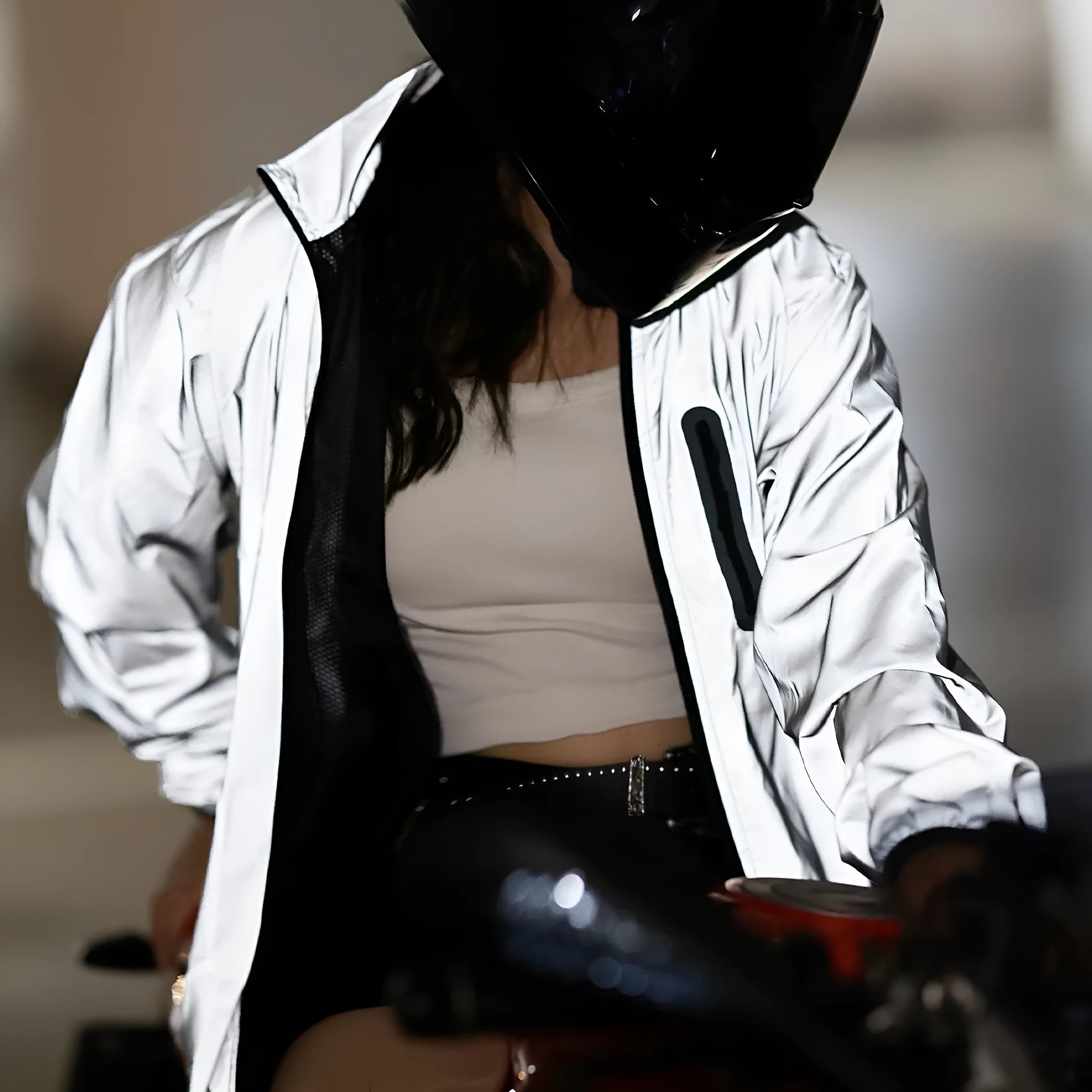 Silver waterproof polyester long-sleeved top displayed on a hanger, showing full sleeves and front closure.