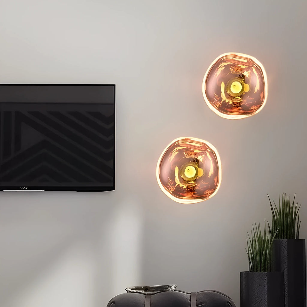 Modern creative lava wall lamp with acrylic shade, 30x18cm, gold finish, on a wall emitting warm light