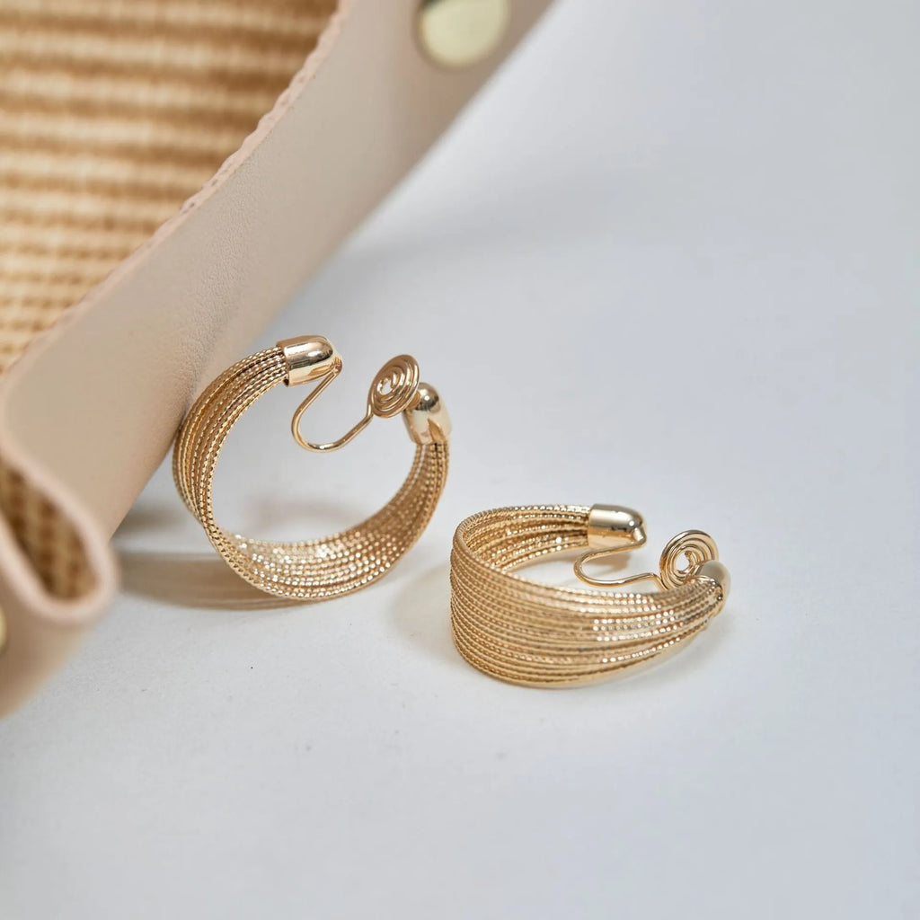 Multi-layer geometric copper earrings with electroplated gold or silver finishes, available as stud or clip styles