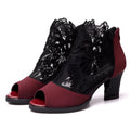 Black women's lace gladiator sandals with a zip closure, floral pattern, and a square high heel on a rubber outsole.