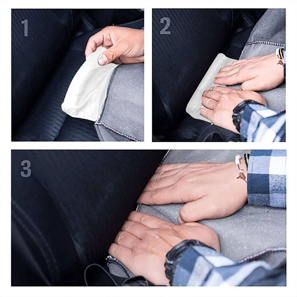 Black polyester car seat cover with elastic straps, foam padding, and rear pocket installed on a car seat