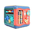 Colourful six-sided Montessori educational toy cube showing bead maze, gears, car track, clock, butterfly, and number activities