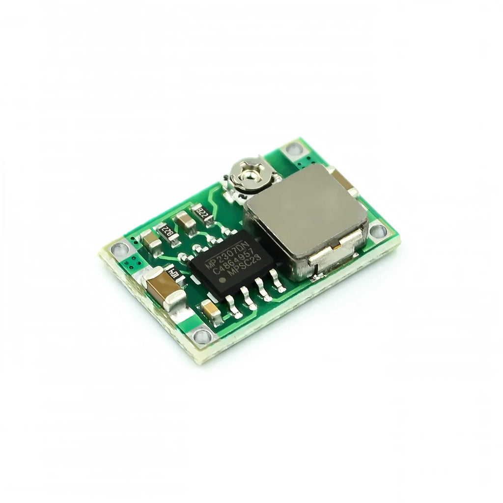 Mini-360 green DC-DC buck converter step down power module on white background