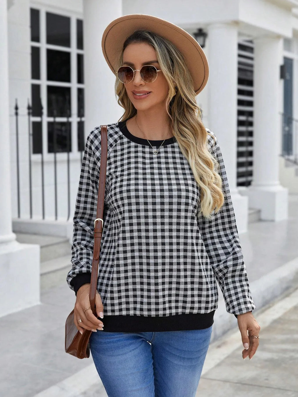 Black long sleeve pullover sweater with plaid stripes and printed pattern on a mannequin.