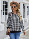 Black long sleeve pullover sweater with plaid stripes and printed pattern on a mannequin.