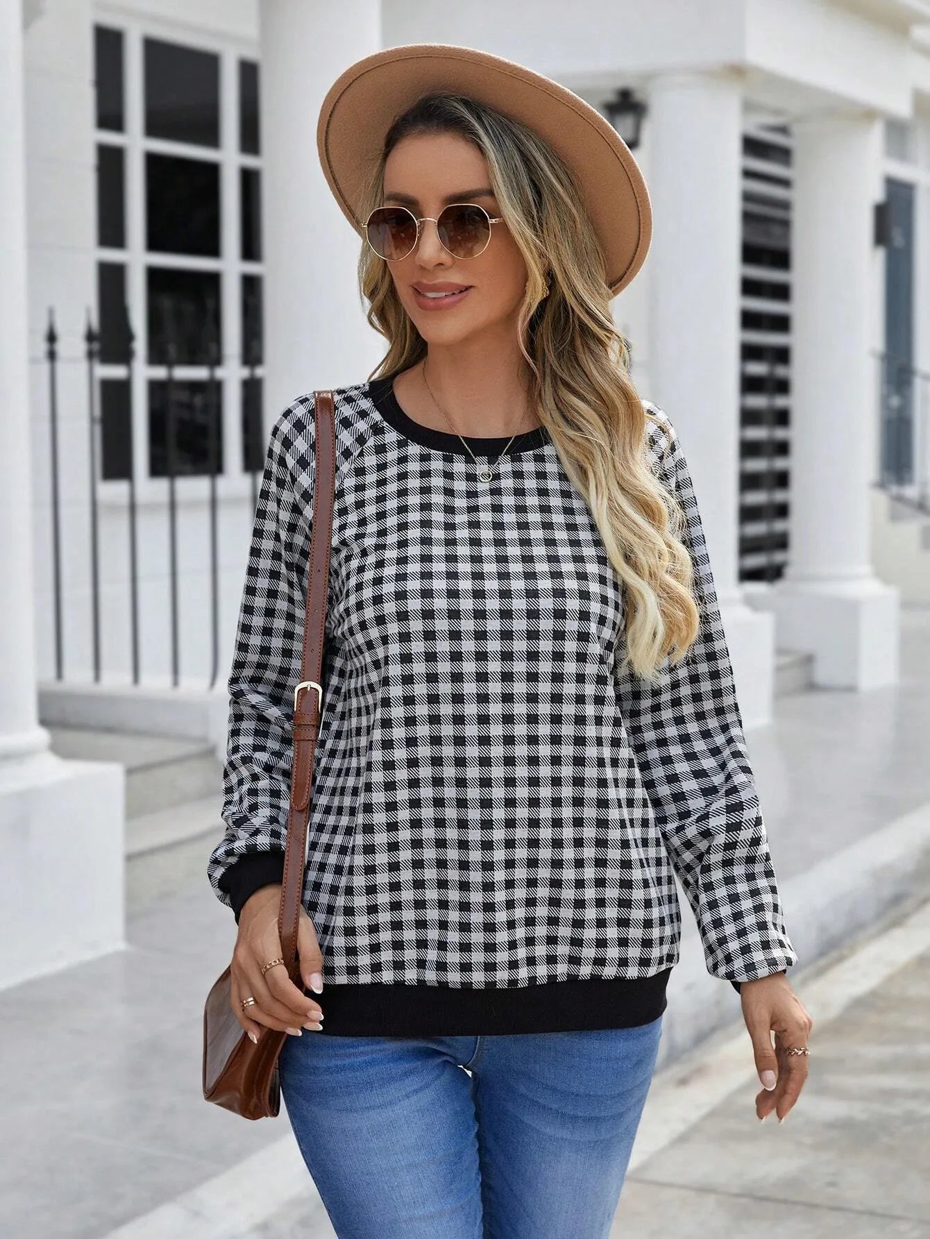 Black long sleeve pullover sweater with plaid stripes and printed pattern on a mannequin.