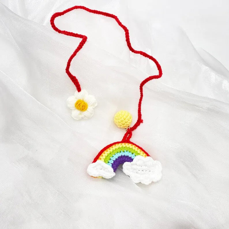 Handmade crocheted avocado-shaped car pendant in wool, shown in three colour variations.