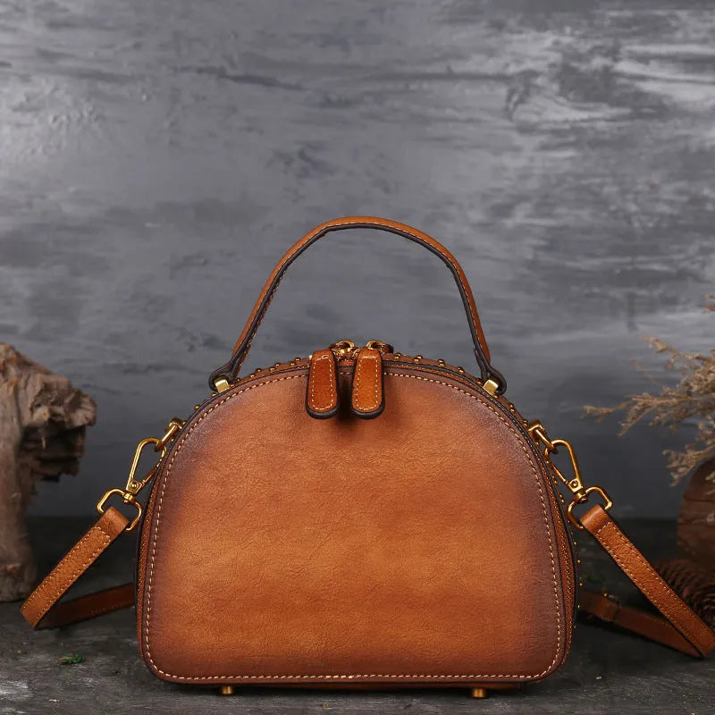 Vintage leather handbag showing internal organisation pockets including mobile phone compartment and ID bag