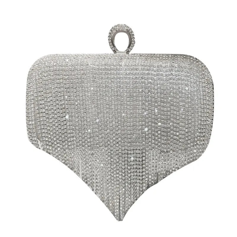 Silver ladies fringed hand bag with shiny diamond embellishments and clasp closure on a plain background