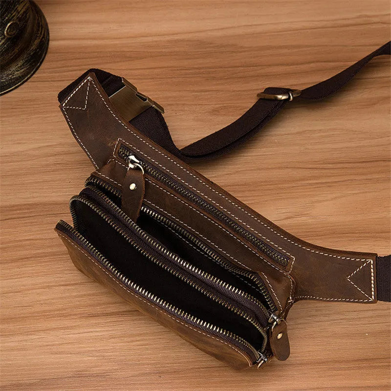 Brown cow leather men's sports waist bag with pull closure showing internal phone compartment
