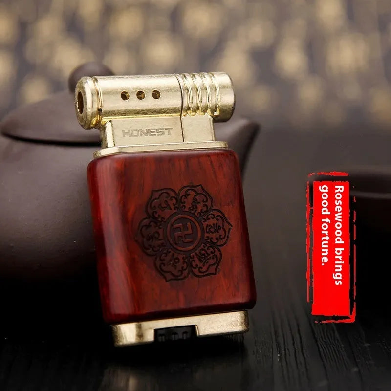 Black wood finished ebony gas lighter with rosewood decorative patterns including sun face and good luck symbols