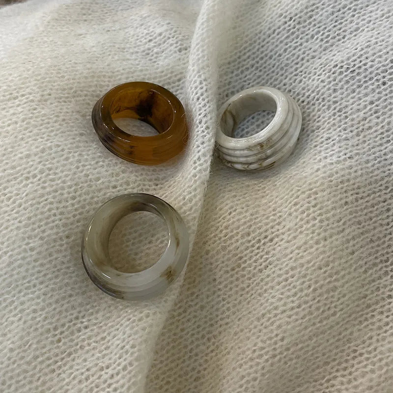 Chinese style irregular geometric resin ring in wide band design showing brown and white colour options