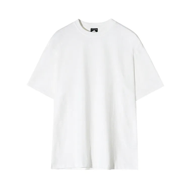 Men's slim fit solid colour cotton t-shirt on a model, showing round neck and half sleeves in white or black.