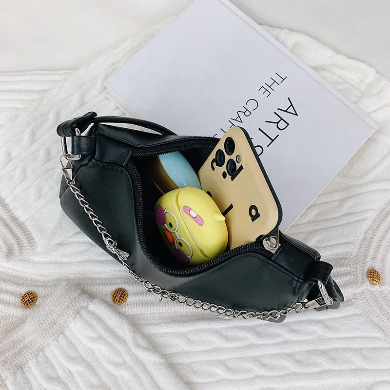 Women's black PU leather butterfly chain crossbody bag with convertible strap showing internal organisation compartments