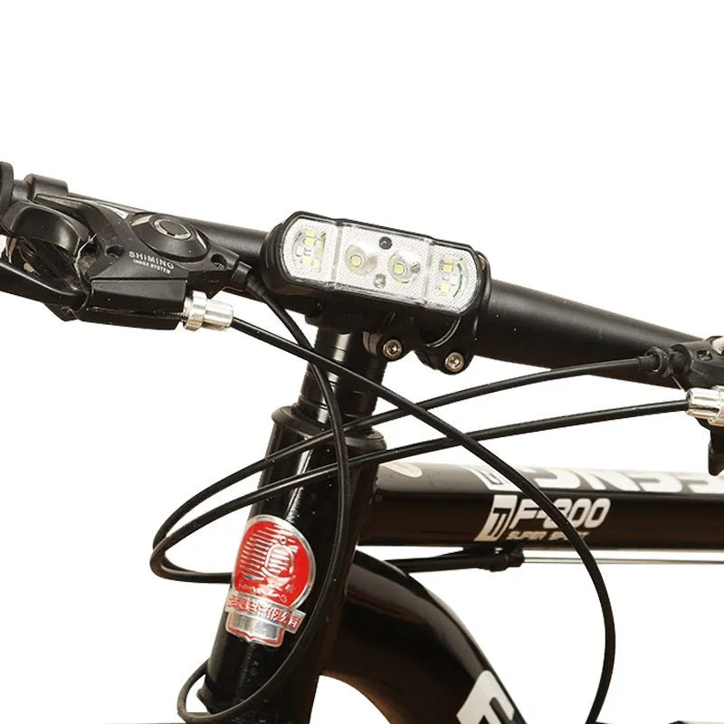 Black bicycle headlight with 350 lumen LED and removable 18650 battery mounted on handlebars
