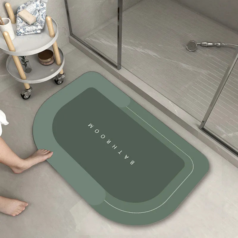 Blue oval blended bathroom floor mat on tiled floor next to a bath.
