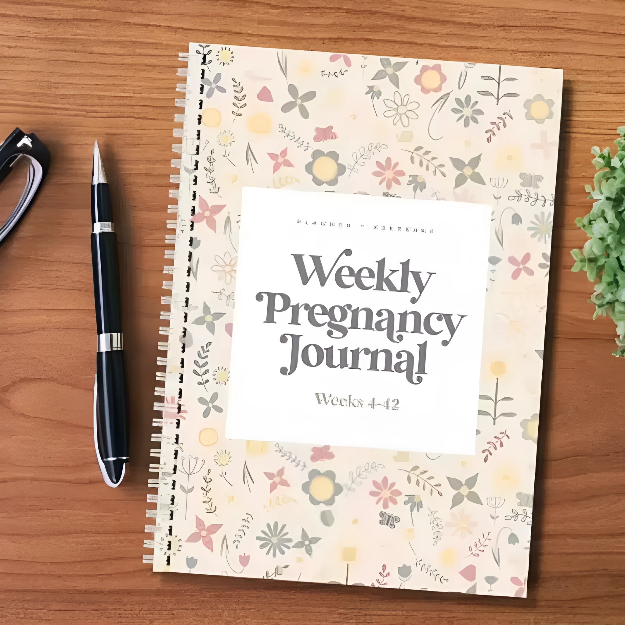 A5 weekly pregnancy diary notebook open to show weekly tracking pages