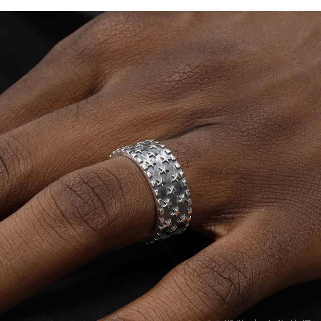 Adjustable silver ring with a multi five-pointed star geometric pattern.