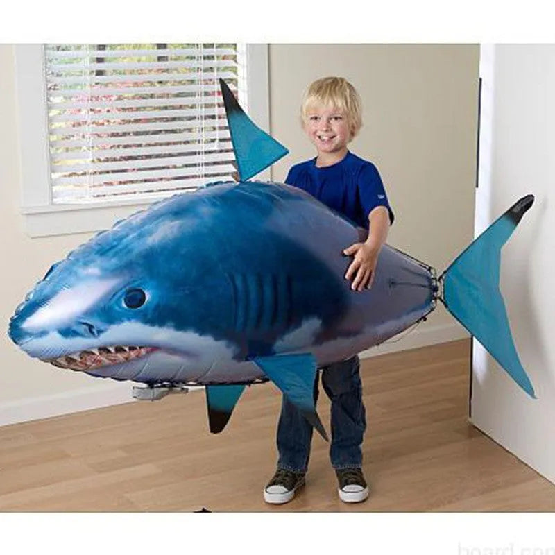 Large remote control shark inflatable balloon toy floating indoors with remote.